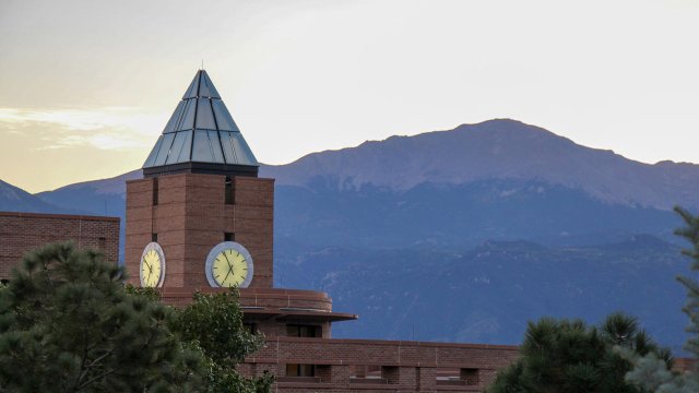 El Pomar clock tower at dusk with Pike's Peak in the background