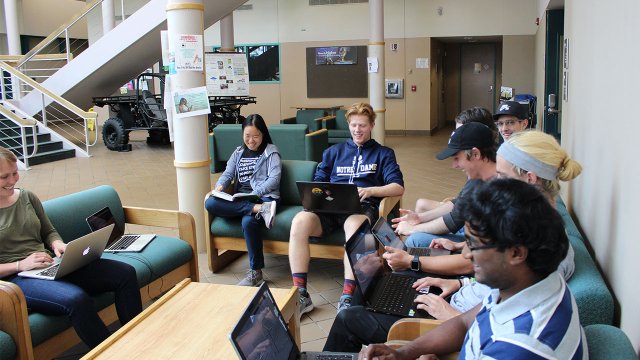 students studying in the lobby of the EAS building