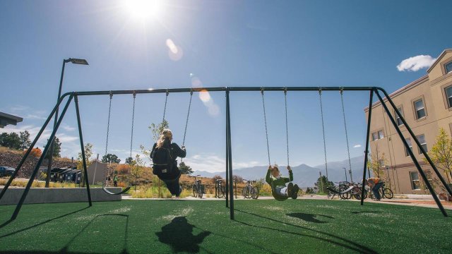 student swing set in the Alpine Village courtyard