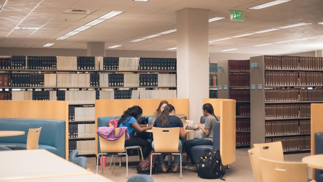 students working together at a table in the library