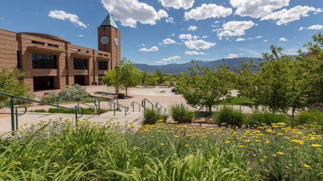 the Kraemer Family Library in the Summer with clear skies and mountains in the background