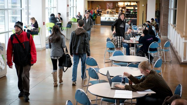 students studying and eating inside the Upper University Center