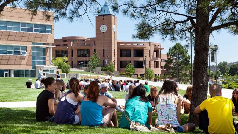 students participating in a group outside on one of the many green areas on campus